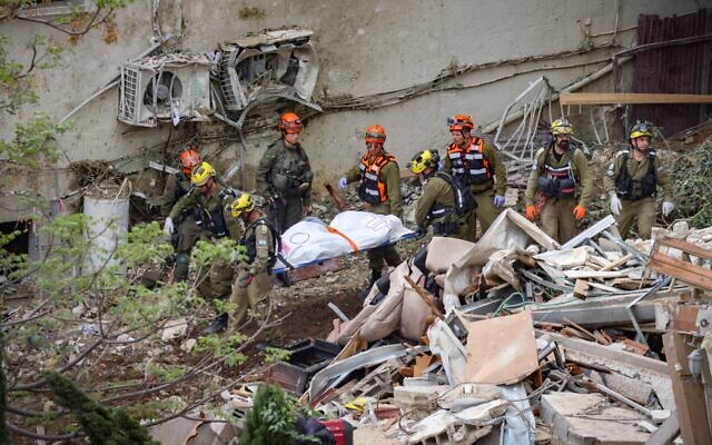 Israeli rescue forces recover bodies at the scene where a missile fired from Iran struck a building in Haifa, April 6, 2026. (David Cohen/Flash90) Israeli rescue forces recover bodies at the scene where a missile fired from Iran struck a building in Haifa, April 6, 2026. (David Cohen/Flash90)