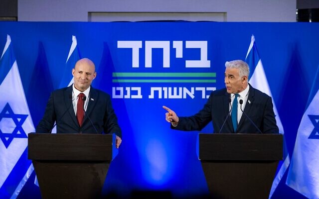 Opposition Leader and Head of the Yesh Atid party Yair Lapid and former Prime Minister Naftali Bennett speak during a press conference announcing a joint list named “Together” ahead of upcoming elections, to be led by Bennett, in Herzliya, Israel, April 26, 2026. (Chaim Goldberg/Flash90)