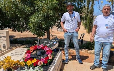 Eyal Golan, left, and his father Meir visit the grave of Eyal's sister Shirel, who died by suicide after surviving the Oct. 7 massacre at the Nova music festival, Tel Mond, Israel, April 21, 2026. (Deborah Danan)