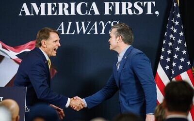 Ed Gallrein, Republican congressional candidate for Kentucky, greets U.S. Secretary of Defense Pete Hegseth on stage during an event one day before Gallrein's primary against Rep. Thomas Massie, May 18, 2026 in Hebron, Kentucky. (Jon Cherry/Getty Images)