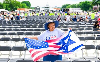 A woman holds a combination American-Israeli flags during Rededicate 250: A National Jubilee Of Prayer, Praise & Thanksgiving on the National Mall on May 17, 2026 in Washington, DC. (Pete Kiehart for The Washington Post via Getty Images)