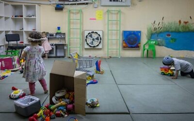 Children play in a public bomb shelter in the Nahlaot neighborhood of central Jerusalem, June 8, 2026. (Chaim Goldberg/Flash90)