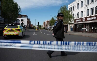 British police investigate the scene after two people were injured in a stabbing attack in the Golders Green area of north London on April 29, 2026. (Rasid Necati Aslim/Anadolu via Getty Images)
