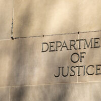 The  lettering on the side of the Justice Department headquarters building in Washington, DC. (Photo by Greggory DiSalvo via iStock)
