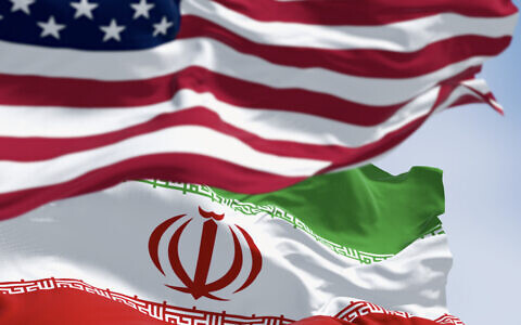 USA and Iran flags waving together (Photo by rarrarorro via iStock)
