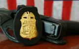 FBI badge and gun (Credit: U.S. Federal Government/Public Domain via Wikimedia Commons)