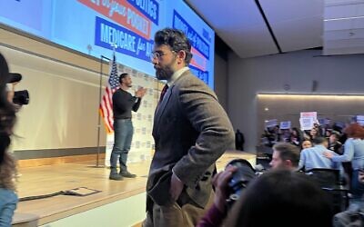Hasan Piker looks on as U.S. Senate candidate Abdul El-Sayed delivers a stump speech in Ann Arbor, Michigan, April 7, 2026. Piker, a popular Twitch streamer accused of antisemitism, prompted controversy for campaigning with El-Sayed. (Andrew Lapin/JTA)