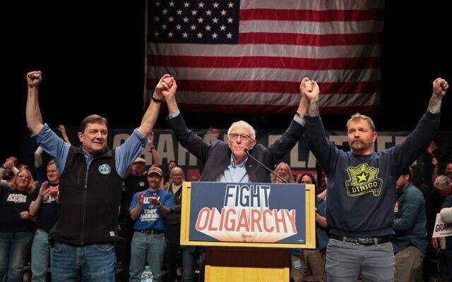 Sen. Bernie Sanders (center) stands with Troy Jackson (left), who is now running for the Democratic nomination for U.S. Senate, and  Graham Platner (right), who was then the Democrats' presumptive nominee, during Sanders' “Fighting Oligarchy” tour, May 24, 2026, in Orono, Maine. (Joe Raedle/Getty Images)