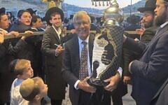 Dennis Hurwitz carries the Torah dedicated in his daughter’s memory at Yeshiva Migdal Ohz in suburban Jerusalem (Photo courtesy of Dennis Hurwitz)