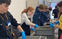 Community Day School students prepare food inside Our Giving Kitchen. (Photo courtesy of Community Day School)