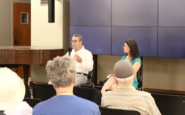 Daniel Stern, seated with the Holocaust Center’s Emily Loeb, shares his family’s story of survival during the Holocaust. (Photo by Octavia Liku)