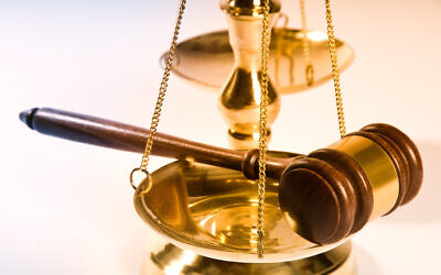 Wooden justice gavel and block with brass. (Photo by YanC, iStock)