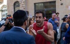 Haredi Orthodox and secular protesters and counter protesters face off outside a Jerusalem cafe open on Shabbat, Aug. 9, 2026 (Theia Chatelle)