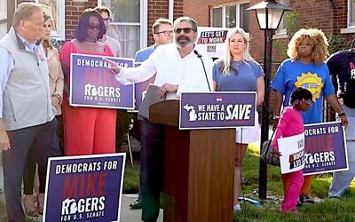 Republican U.S. Senate candidate Mike Rogers, at left, looks on as Rabbi Asher Lopatin, the former director of Community Relations at the Jewish Federation of Greater Ann Arbor, speaks in support of his campaign in Detroit, Michigan, Aug. 20, 2026. (Screenshot via YouTube)
