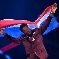 Dutch singer Claude Kiambe parades during the flag ceremony prior to the grand final of the Eurovision Song Contest 2025 at the St. Jakobshalle arena in Basel, May 17, 2025. (Fabrice COFFRINI / AFP)