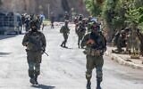 Israeli soldiers patrol a street as they are deployed during an operation in the village of Qusra, south of Nablus, in the Israeli-occupied West Bank, on August 13, 2026. Photo by Zain JAAFAR / AFP via Getty Images