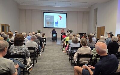 Jo Recht addresses those attending a town hall to learn more about the Tree of Life. She's joined by Diane Rosenthal and 10.27 Healing Partnership Executive Director Maggie Feinstein. (Photo by David Rull)