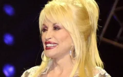 Music legend Dolly Parton on stage at the Grand Ole Opry during a live broadcast in Nashville, Tenn., on April 23, 2005. (Credit: U.S. Department of Defense photo by Tech. Sgt. Cherie A. Thurlby, U.S. Air Force/Public Domain via Wikimedia Commons)