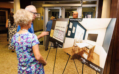 Attendees of the Sept. 2 annual meeting observe renderings of Weinberg Terrace. (Photo courtesy of Jewish Association on Aging)