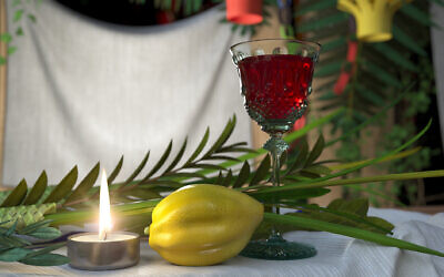 Symbols of the Jewish holiday Sukkot with candle and wine glass (Photo by denisgo via iStock)