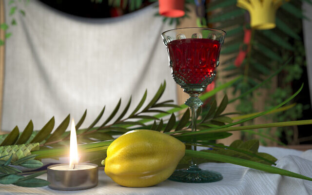 Symbols of the Jewish holiday Sukkot with candle and wine glass (Photo by denisgo via iStock)
