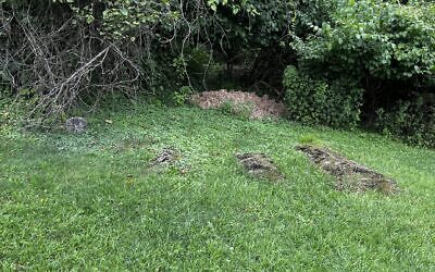 What looked from a distance like several innocuous mounds of dirt were actually unmarked graves, set apart from the rest of the cemetery. (Photo by Eric Lidji)