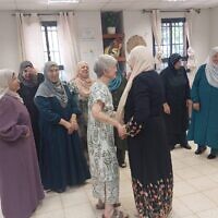 Israeli poet Hamutal Bar-Yosef greets Palestinian neighbors. (Courtesy of Sheep Meadow Press, via the Forward)