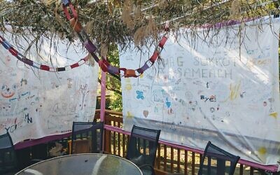 The walls of Carl Fertman and Barb Murock's sukkah tell a decades-long story. (Photo courtesy of Carl Fertman)