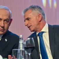 Prime Minister Benjamin Netanyahu (left) speaks to then-Mossad chief David Barnea at Mossad headquarters during a New Year toast on September 14, 2023. (Kobi Gideon/GPO)
