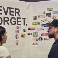 Participants of an Oct. 7 commemoration at the Squirrel Hill JCC reflect on lives lost. (Photo by Adam Reinherz)