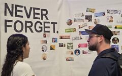 Participants of an Oct. 7 commemoration at the Squirrel Hill JCC reflect on lives lost. (Photo by Adam Reinherz)