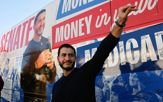 Abdul El-Sayed, U.S. Democratic Senate candidate from Michigan, waves to supporters near his campaign bus after a rally in Flint, Michigan, Oct. 18, 2026. (JEFF KOWALSKY / AFP)