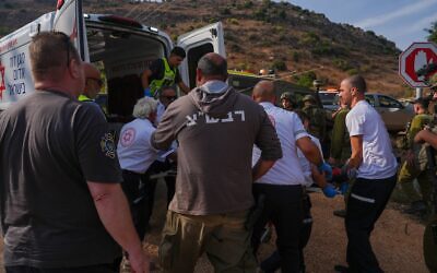 Israeli security and rescue forces evacuate injured people near the site where suspected unexploded ordnance detonated during a school trip near Kibbutz Yiftah in the Ramim Ridge area, close to the Israeli border with Lebanon, October 12, 2026. Photo by Ayal Margolin/Flash90