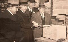 Rabbi Herman Hailperin (left) watches as members of the Tree of Life building committee prepare the cornerstone for the original section of the congregation's synagogue at Wilkins and Shady. A time capsule was placed inside the cornerstone at the time and was removed during demolition work in early 2024. (Photo courtesy of the Rauh Jewish Archives)