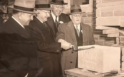 Rabbi Herman Hailperin (left) watches as members of the Tree of Life building committee prepare the cornerstone for the original section of the congregation's synagogue at Wilkins and Shady. A time capsule was placed inside the cornerstone at the time and was removed during demolition work in early 2024. (Photo courtesy of the Rauh Jewish Archives)