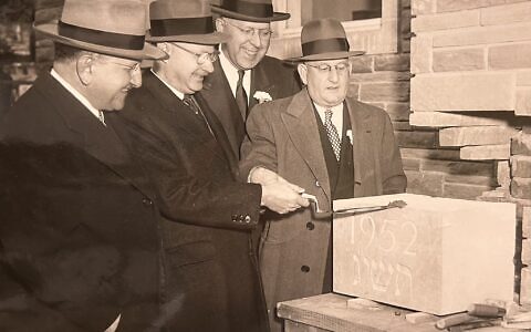 Rabbi Herman Hailperin (left) watches as members of the Tree of Life building committee prepare the cornerstone for the original section of the congregation's synagogue at Wilkins and Shady. A time capsule was placed inside the cornerstone at the time and was removed during demolition work in early 2024. (Photo courtesy of the Rauh Jewish Archives)