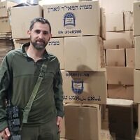 Yedidya Harush stands next to boxes of matzah made in his matzah bakery in Netivot on April 8, 2024.  (Photo by Maya Zanger-Nadis/Times of Israel)