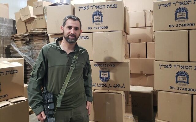Yedidya Harush stands next to boxes of matzah made in his matzah bakery in Netivot on April 8, 2024.  (Photo by Maya Zanger-Nadis/Times of Israel)