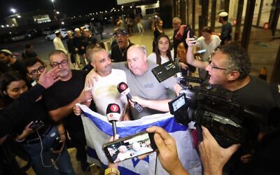 Yaniv Hayun (C), one of the men who helped incapacitate the attacker on the flydubai aircraft bound for Israel from the United Arab Emirates, which was diverted to Saudi Arabia following an emergency signal, is welcomed after arriving at the Ben Gurion International Airport. (Jamal Awad/picture alliance via Getty Images)