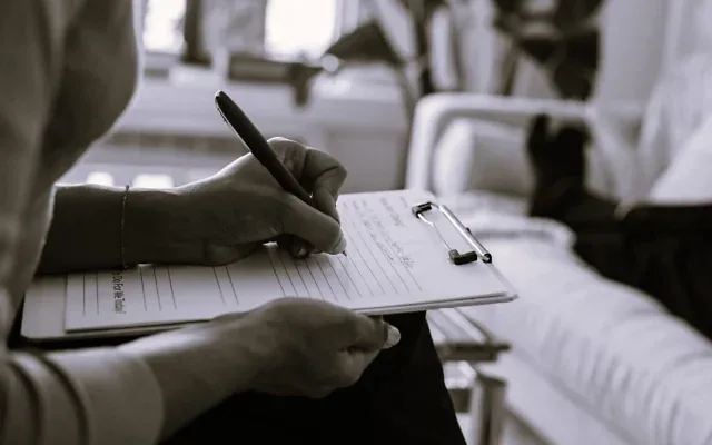 Therapist taking patient notes (Credit: Alex Green/Pexels)