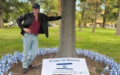 Lawrence Puccini with his Oct. 7 memorial at the University of New Mexico, Oct. 7, 2026. (Credit: Courtesy, via JNS)