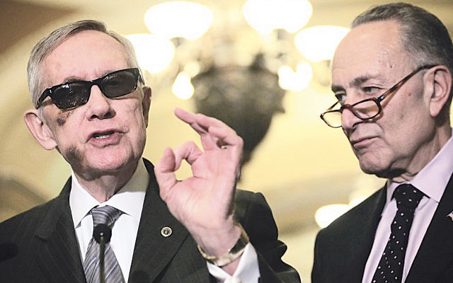 Senator Harry Reid, left, the Senate minority leader, and his likely successor, Senator Charles Schumer, at a news briefing in Washington, D.C., in February. Reid is supporting the Iran deal and Schumer said he will vote against it. (Alex Wong/Getty Images)