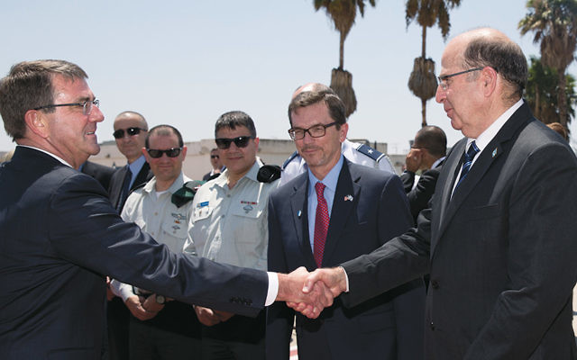 U.S. Defense Secretary Ash Carter, left, shaking hands with his Israeli counterpart, Moshe Yaalon, before boarding a military aircraft at Ben Gurion Airport near Tel Aviv on July 21. (Carolyn Kaster/Pool/AP Images)