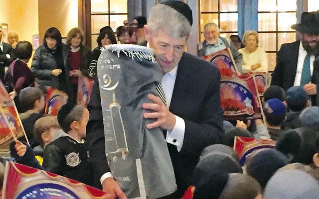 Rabbi Yerachmiel Seplowitz  marched it through the lobby in celebration. (Courtesy FountainView)
