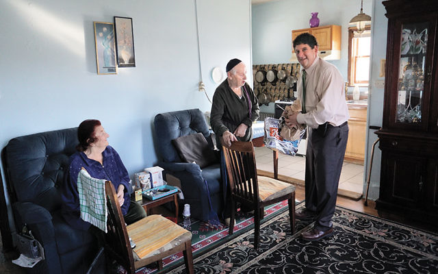 Dennis Gralla visits with Lena and Moshe Strakhman.
