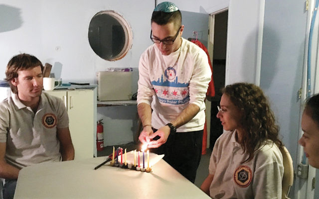 Barak Stoltz lights Chanukah candles in the Mars Desert Research Station. (Courtesy Barak Stoltz)