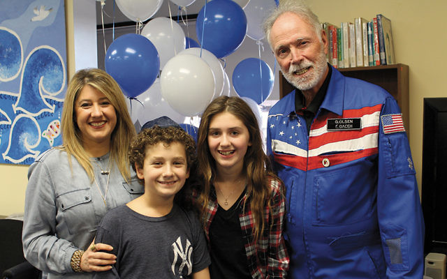 Dr. Gregory Olsen stands with Jackie, Daniel, and Samantha Rigante at the GBDS presentation. (Courtesy GBDS)