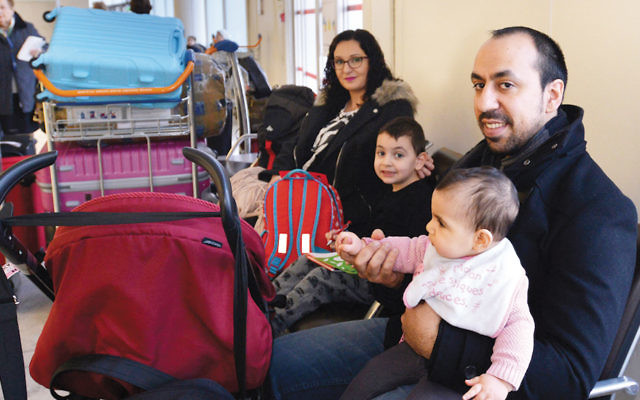 Rudy Abecassis and his family at Charles de Gaulle Airport as they prepare to fly to Israel on December 27, 2015. (Cnaan Liphshiz)