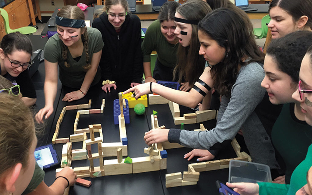 Eighth-graders at Yeshivat Noam guide a Sphero through a maze.