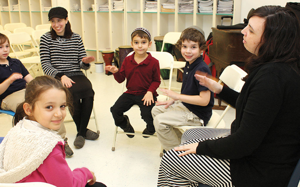 Music teacher Erika Svolos, right, with a group of students. Photos courtesy of Sinai Schools